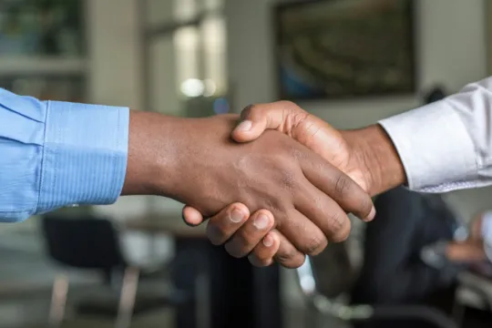 a close-up of a handshake on fedrig services